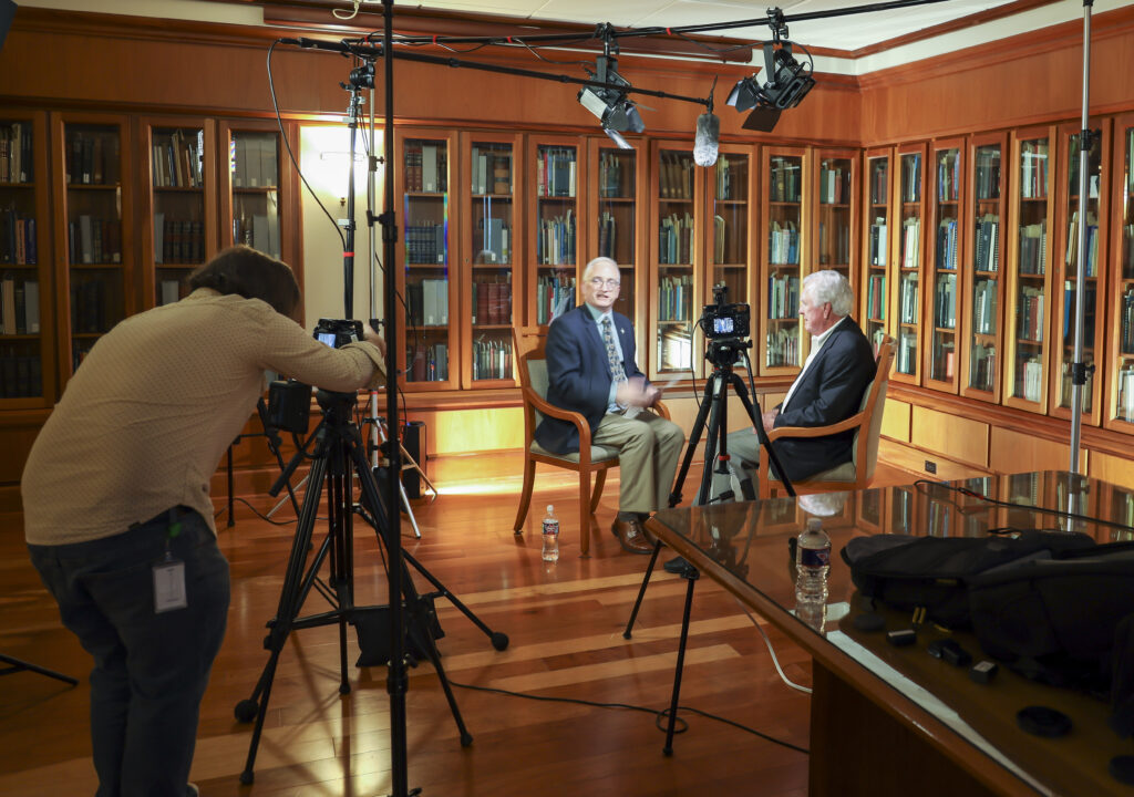 Dan Burgard interviewing Gibson D. Lewis while being video recorded.