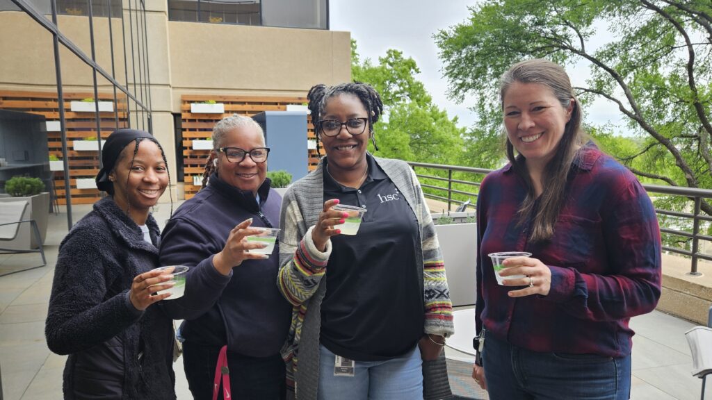 U N T H S C staff visiting the newly renovated second floor balcony at Lewis Library. Balcony Bash 2025